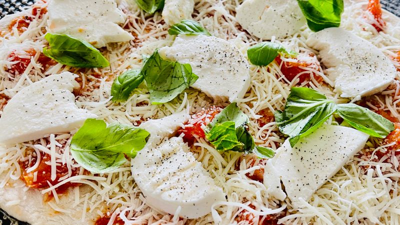 Classic Margherita pizza with fresh basil and tomato